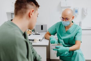 A man looking at a dental implant