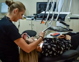 Dental hygienist cleaning a women's teeth. Creekside Dental Idaho Falls